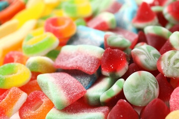Tasty colorful jelly candies as background, closeup view