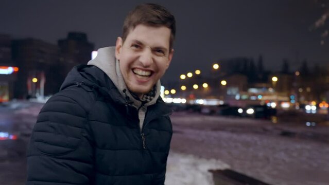 Young male bursts in laughter while talking to camera, video bloopers