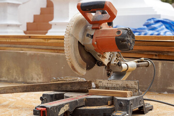 A miter saw is a tool that allows you to cut at various angles. You can use a miter saw to quickly cut picture frames, door frames, window frames, and more. Soft and selective focus.