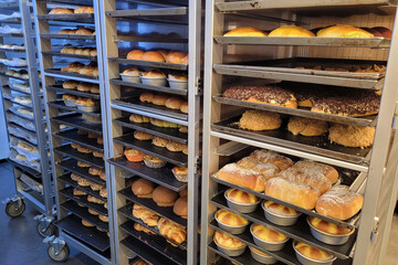 Freshly oven baked breads and buns on stainless steel cooling rack