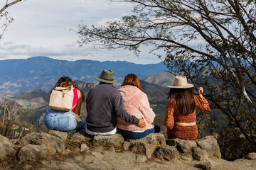 Mexican family enjoying the view from the top of a mountain.
