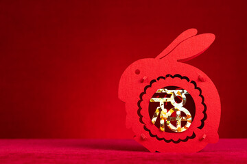 Chinese New Year of Rabbit mascot paper cut on red background with copy space at horizontal...