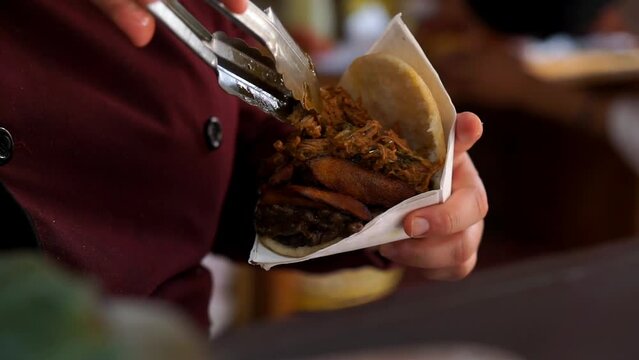 Close-up of the preparation of an arepa, Venezuelan food, horizontal video.