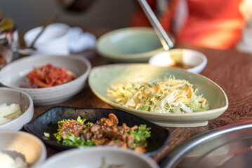 Assortment of Korean food in a Korean traditional restaurant. Salad with sweat saurce.