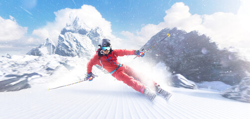 Rapid descent at high speed. Skier skiing on a sunny day in high mountains. Downhill. Ski skiing in...