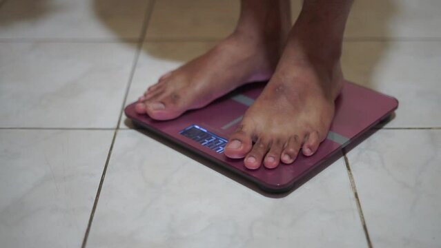 Man Feet Standing Weighing Scales, Checking BMI Weight Loss. Barefoot Measuring Body Fat Overweight