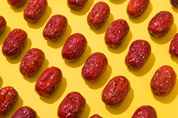 dried red dates isolated on yellow background