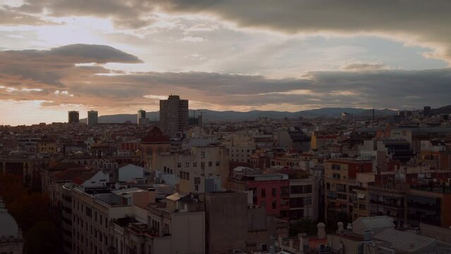 Sunset cityscape Barcelona, Catalonia, Spain. Architectural masterpiece. Cloudy evening. Spanish district city streets view. Panorama. High quality 4k footage
