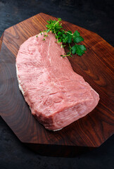 Raw cap of rump calf offered as close-up on a wooden design board with copy space