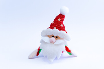 Plush red Santa Claus on a white background. Season of celebration.