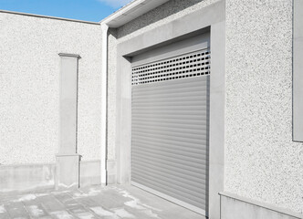 Roller shutter gate. Metal roller garage door as background. Automatic electric roll-up garage...