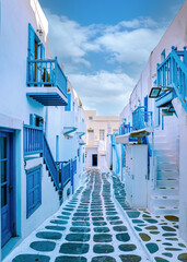 Mykonos Greece, colorful streets of the old town of Mykonos, Traditional narrow street with blue...