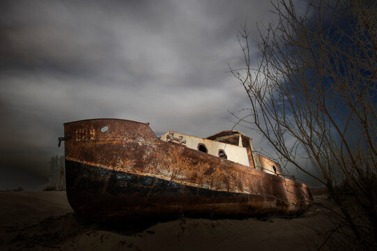 abanedoned fishing boats by the town of muynaq, aral sea, Uzbekistan