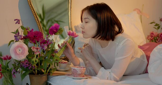 Young Cute Asian woman holding a bouquet in the apartment.
