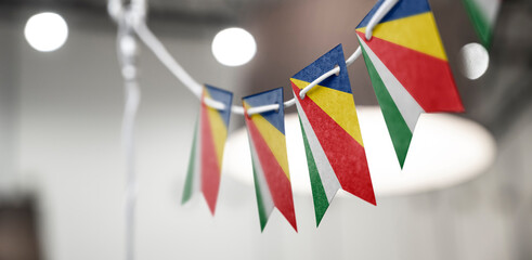 A garland of Seychelles national flags on an abstract blurred background