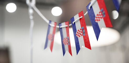 A garland of Croatia national flags on an abstract blurred background