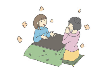 こたつで談笑する女性