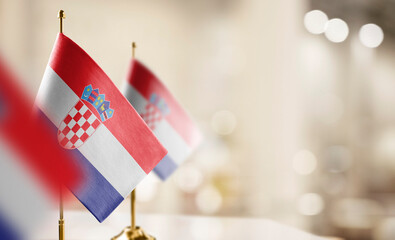 Small flags of the Croatia on an abstract blurry background