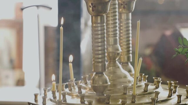 Lit candles in a Christian church close-up. Religious concept.