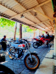 Abstract patchwork background, inside is a pattern resembling a neatly parked motorcycle.