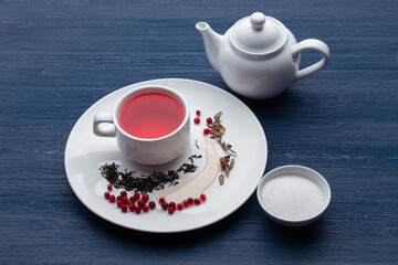 Cup of healthy traditional herbal rooibos red beverage tea on wooden table