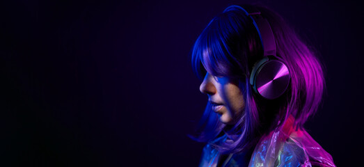 Woman in headphones listening music and enjoing