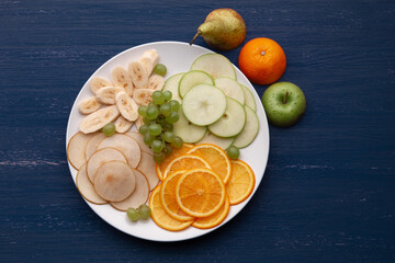 Assortment of tropical fruits on a white plate
