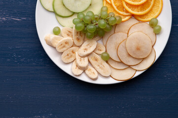 Assortment of tropical fruits on a white plate