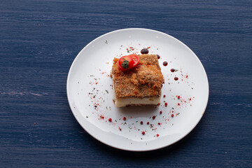 meat dish decorated with tomatoes and herbs