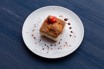 meat dish decorated with tomatoes and herbs