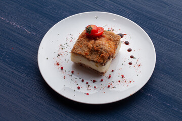 meat dish decorated with tomatoes and herbs