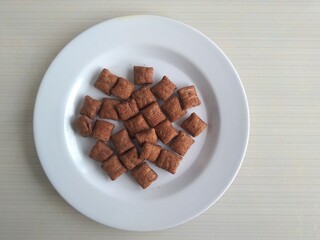 chocolate flavored pillow snacks on the white plate