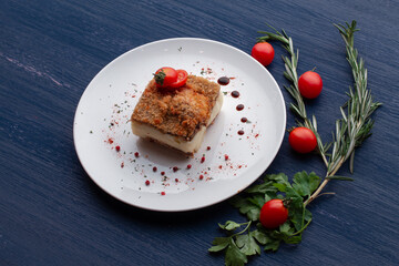 meat dish decorated with tomatoes and herbs