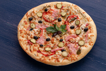 Delicious pizza with olives and sausages on wooden table