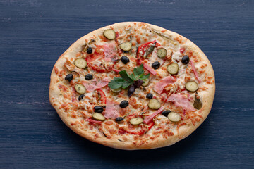Delicious pizza with olives and sausages on wooden table