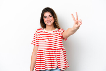 Young caucasian woman isolated on white background smiling and showing victory sign