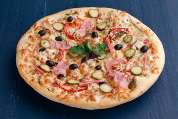 Delicious pizza with olives and sausages on wooden table