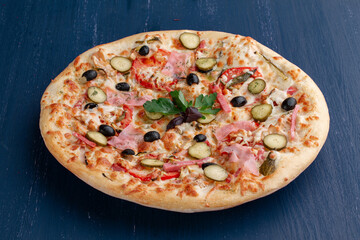 Delicious pizza with olives and sausages on wooden table