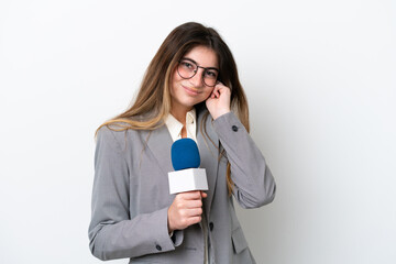 Young caucasian TV presenter woman isolated on white background frustrated and covering ears