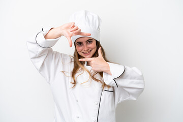 Young caucasian chef woman isolated on white background focusing face. Framing symbol