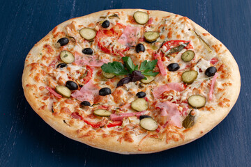 Delicious pizza with olives and sausages on wooden table
