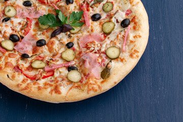Delicious pizza with olives and sausages on wooden table