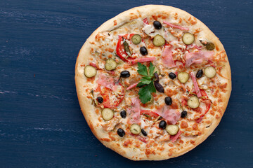 Delicious pizza with olives and sausages on wooden table