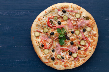 Delicious pizza with olives and sausages on wooden table
