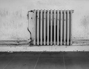old worn radiator heater in black and white