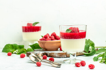Raspberry sorbet with whipped cream and mint. Italian dessert on a light background in small jars. Long banner format. place for text