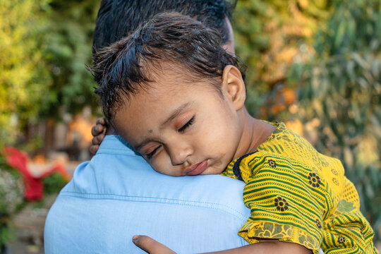 Asian refugee with his sick child at a border