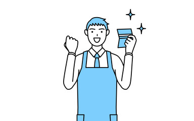 預金通帳を見て喜ぶエプロンを着た男性