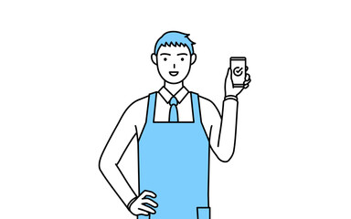 仕事でスマホを使うエプロンを着た男性