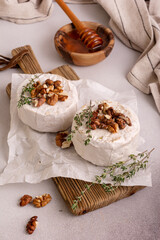 Brie or camembert cheese with thyme, nuts and honey
